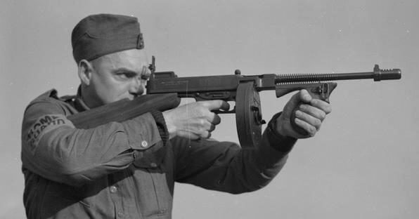 Guardsman aiming a Thompson submachine gun