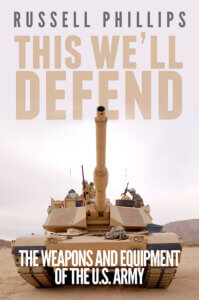 Book cover: This We'll Defend by Russell Phillips. Cover image is of an M1 Abrams tank, seen from the front.